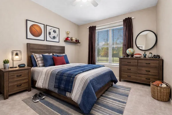 a bedroom with a bed and a dresser