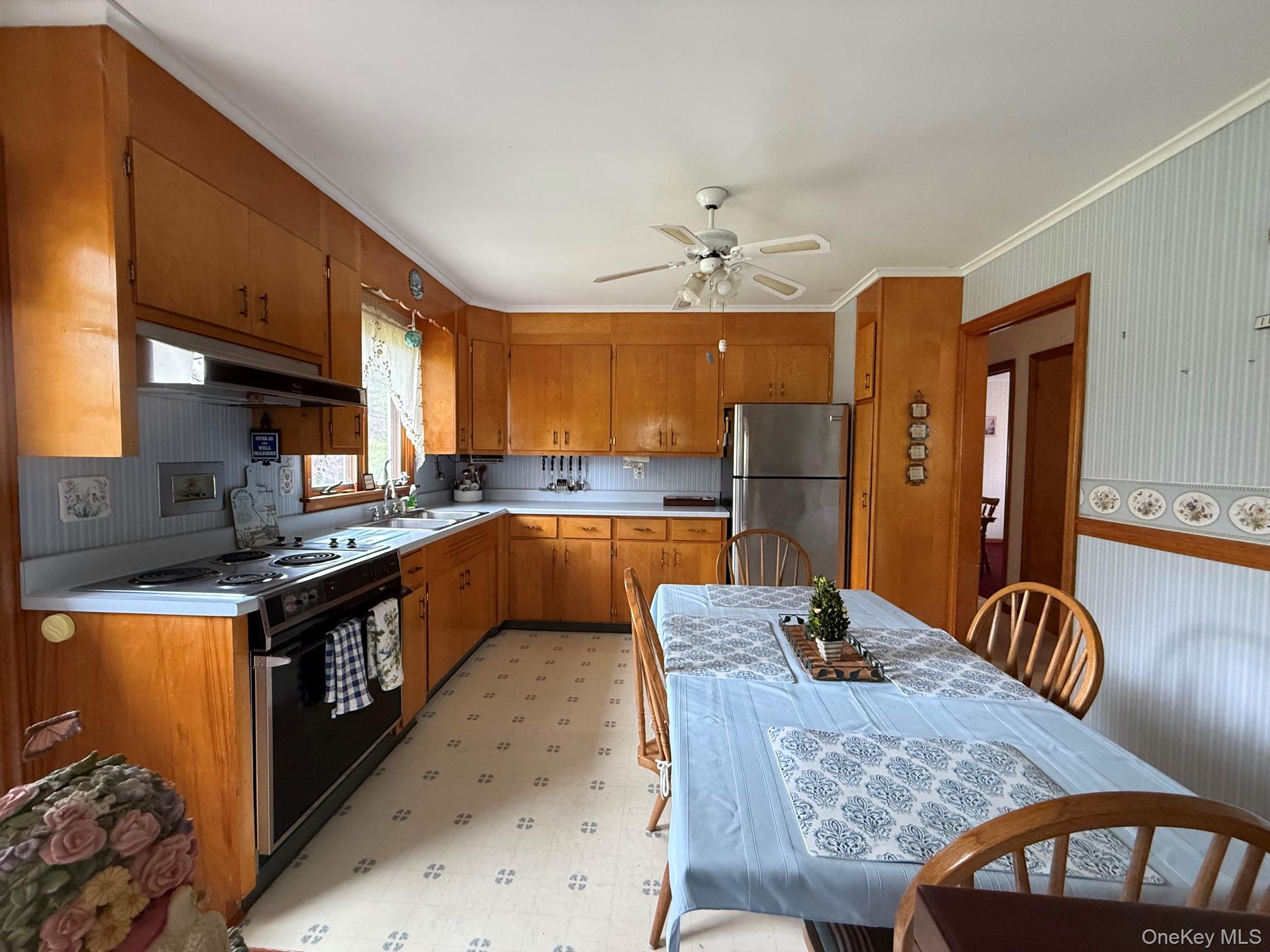 126 Perrys Corners Road Amenia, NY 12501 - Photo 7 of 16 a kitchen with stainless steel appliances granite countertop a kitchen island a stove a refrigerator a sink dishwasher a dining table and chairs with wooden floor