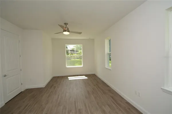 wooden floor in an empty room with a window
