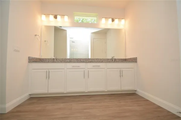 a bathroom with a granite countertop sink and a mirror