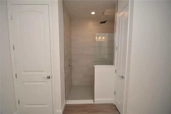 a bathroom with a shower and a glass door