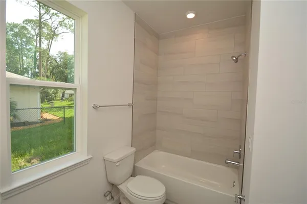 a bathroom with a granite countertop toilet a sink and a shower