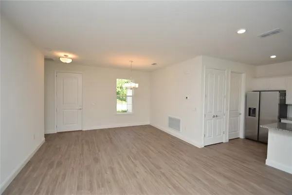 an empty room with wooden floor and a window