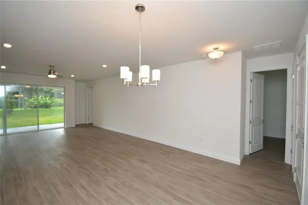 a view of a room with wooden floor and window