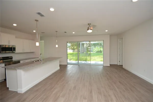 a view of a kitchen with a sink and wooden floor