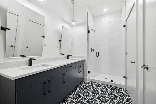 a bathroom with a sink a toilet a shower and a mirror