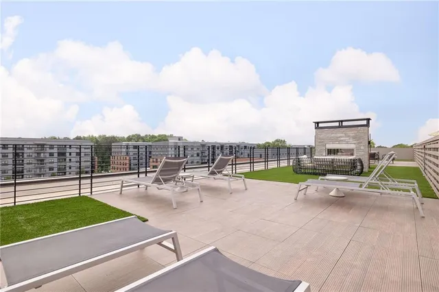 a view of a terrace with lawn chairs