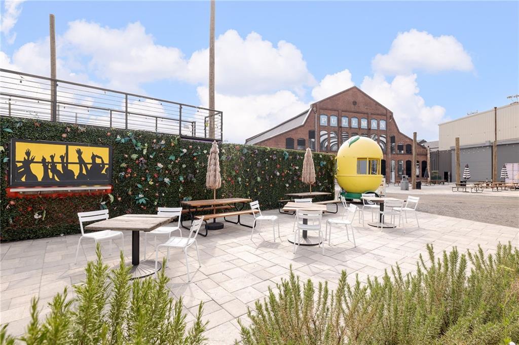 112 Rogers Street Northeast, Unit 304 Atlanta, GA 30317 - Photo 21 of 22 a view of a swimming pool with a table and chairs