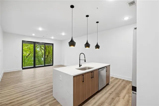 a view of a kitchen with a sink and window