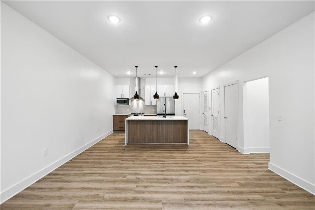 112 Rogers Street Northeast, Unit 304 Atlanta, GA 30317 - Photo 5 of 22 a view of kitchen with wooden floor