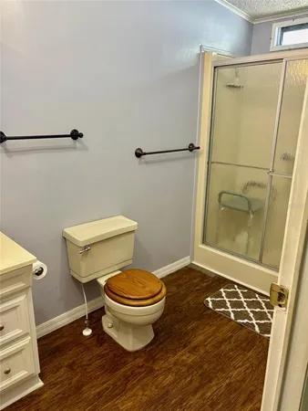 a bathroom with a toilet and a shower