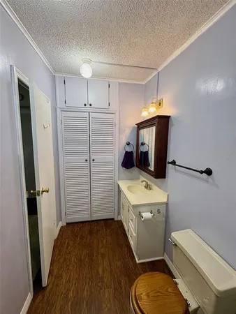 a bathroom with a granite countertop toilet sink and mirror