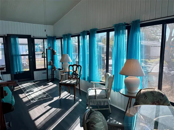 a living room with furniture and a floor to ceiling window