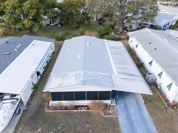 an aerial view of a house with a yard