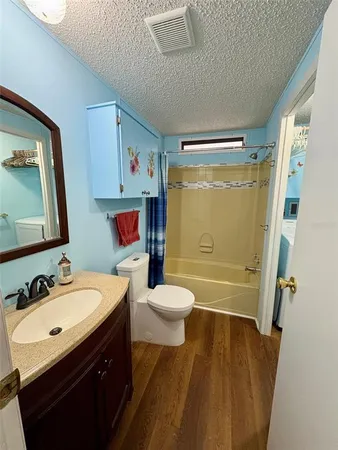 a bathroom with a sink toilet tub and shower