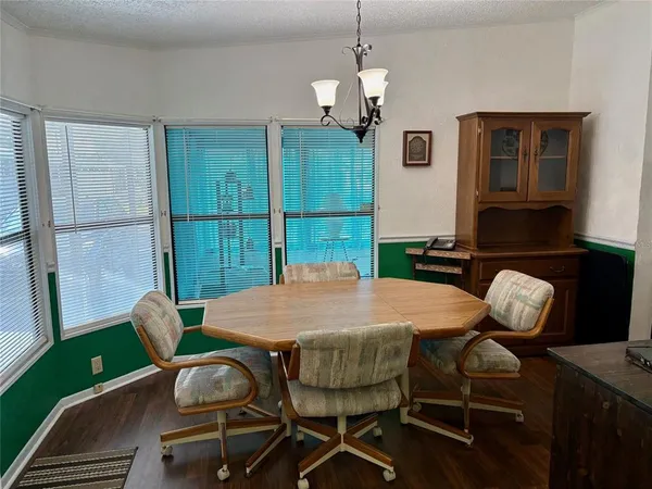a dining room with furniture a rug and wooden floor