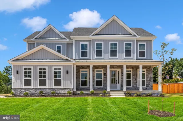 a front view of a house with a yard and sitting area