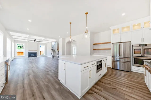 a large kitchen with stainless steel appliances granite countertop a stove and a refrigerator