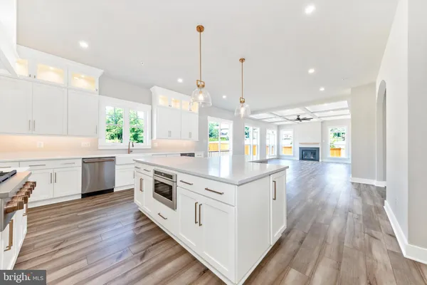 a kitchen with stainless steel appliances granite countertop hardwood floor sink stove and wooden floor
