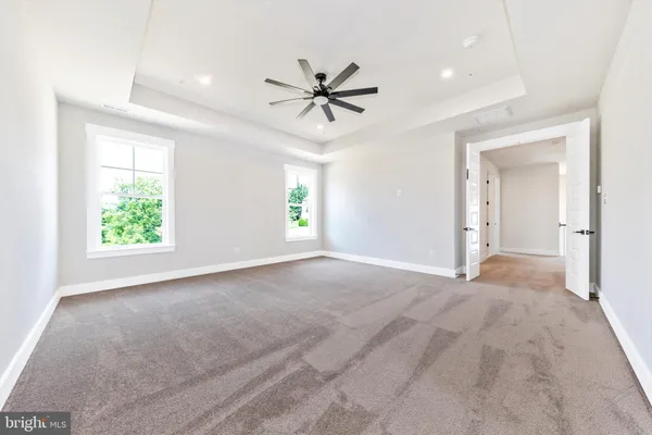a view of a livingroom with a window and a ceiling fan