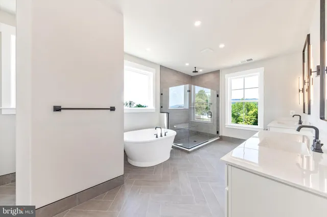 a bathroom with a sink a bathtub and window