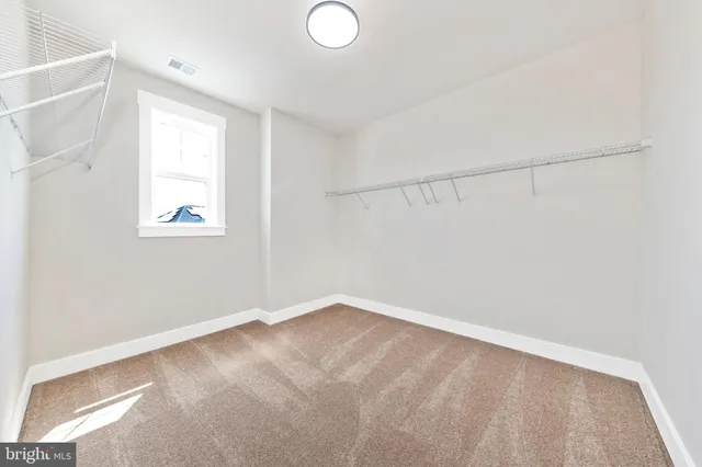 a bathroom with a sink a toilet a mirror and shower