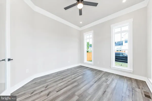 wooden floor in an empty room with a window