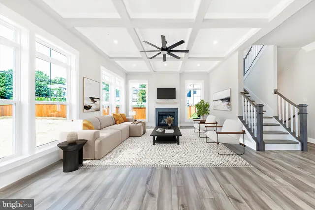 a living room with furniture fireplace and a large window
