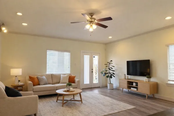 a living room with furniture and a flat screen tv