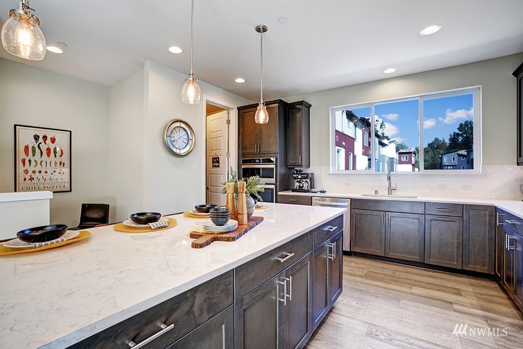 518 238th Street Southeast, Unit A Bothell, WA 98021 - Photo 12 of 31 a kitchen with a sink stove and cabinets