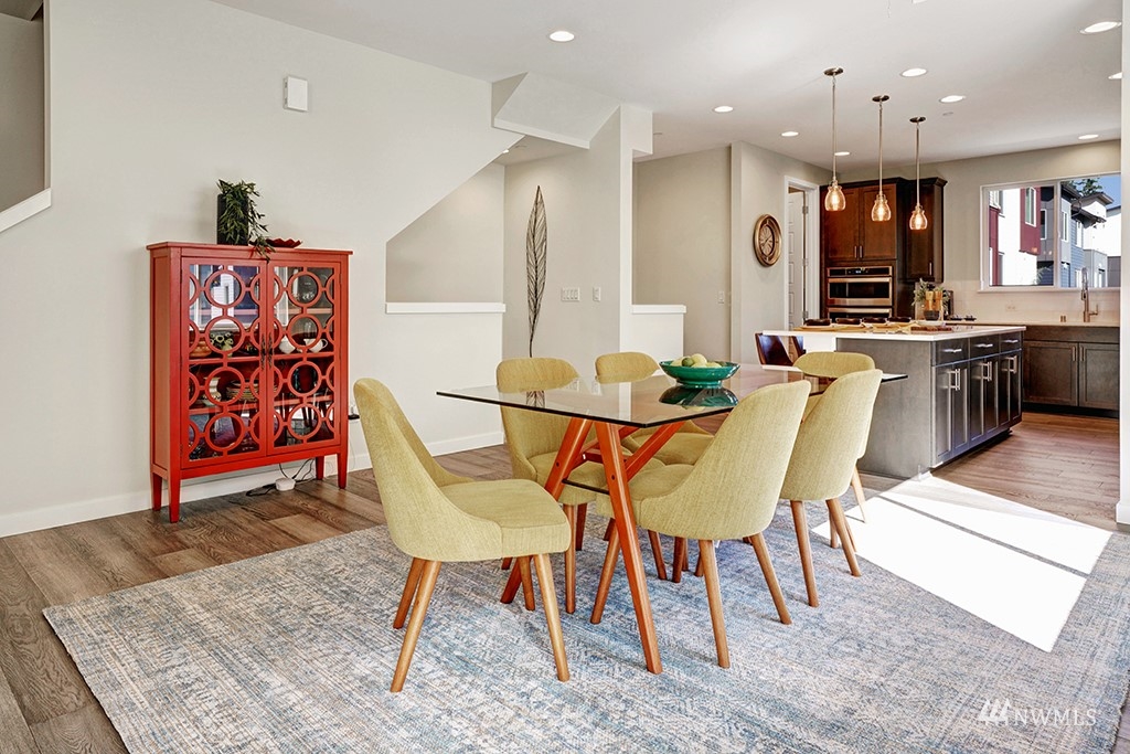 518 238th Street Southeast, Unit A Bothell, WA 98021 - Photo 13 of 31 a dining room with stainless steel appliances kitchen island granite countertop a dining table chairs and a refrigerator