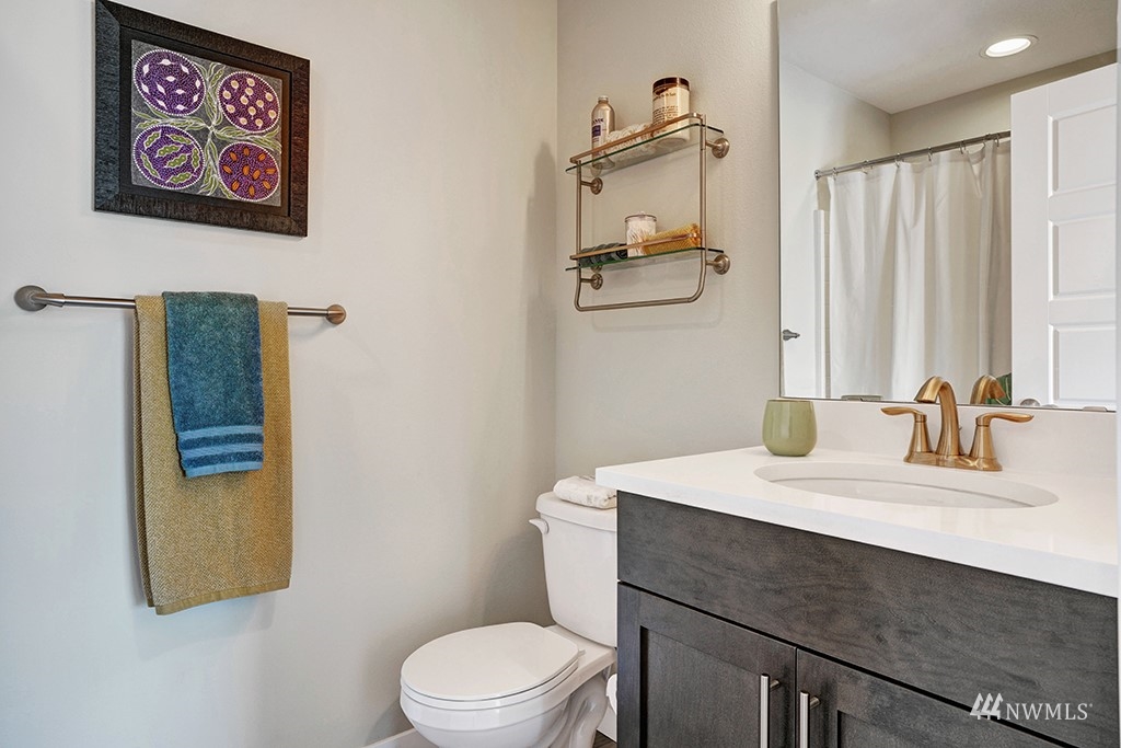 518 238th Street Southeast, Unit A Bothell, WA 98021 - Photo 18 of 31 a bathroom with a sink a toilet and mirror