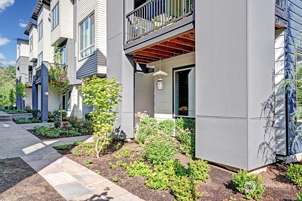 518 238th Street Southeast, Unit A Bothell, WA 98021 - Photo 31 of 31 a front view of a multi story residential apartment building with yard and retail shops