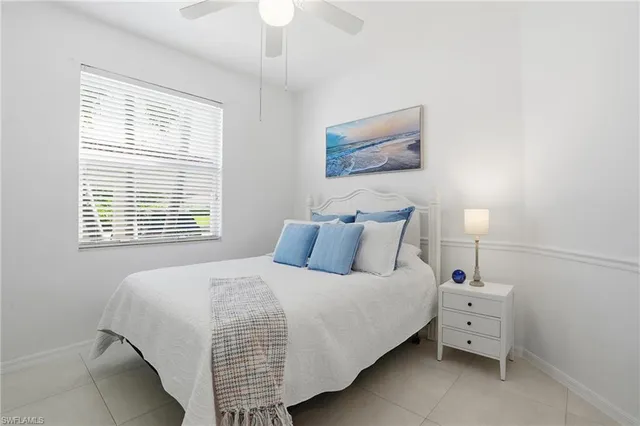 a bedroom with a bed and a white wall with exposed radiator