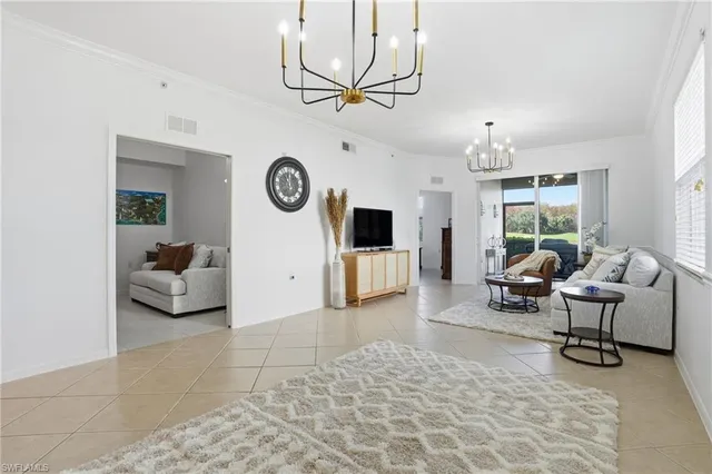 a living room with furniture a window and a clock
