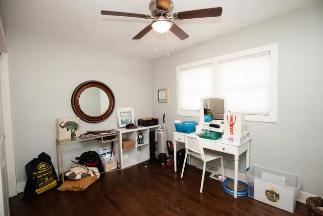 a work room with furniture a rug and a window
