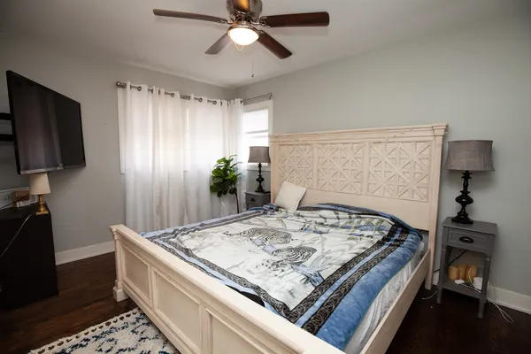 a living room with a bed and a chandelier