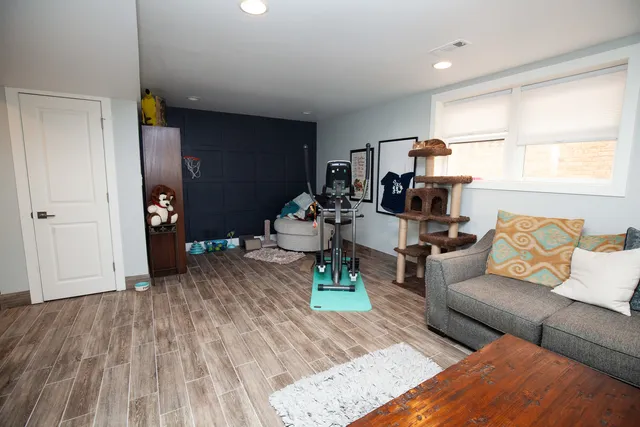 a living room with furniture and wooden floor