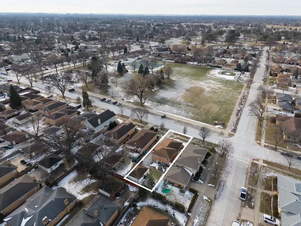 an aerial view of residential houses with city view