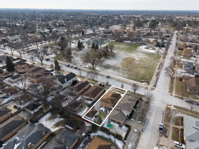 an aerial view of residential houses with city view