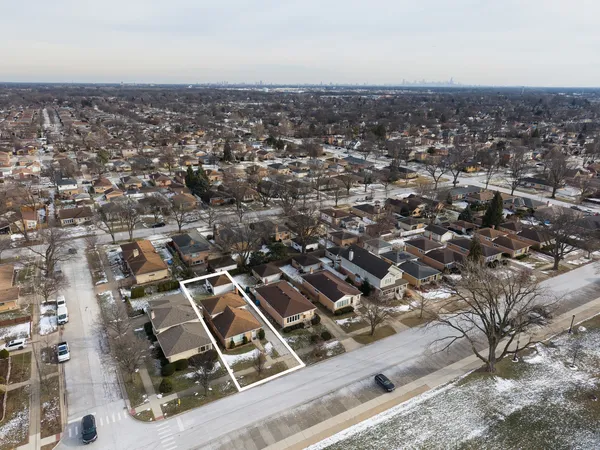 an aerial view of residential houses with city view