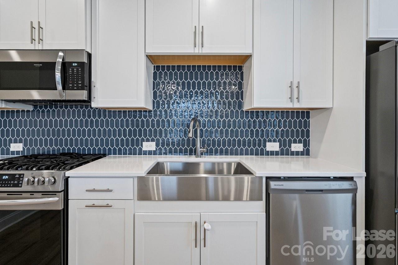 1515 Hidden Falls Road Charlotte, NC 28206 - Photo 15 of 35 a kitchen with a stove and a microwave