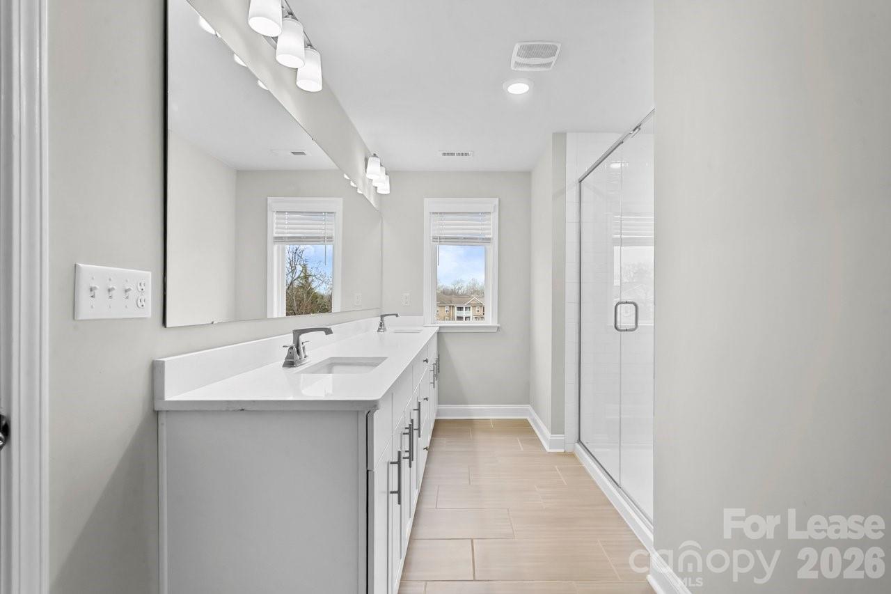 1515 Hidden Falls Road Charlotte, NC 28206 - Photo 21 of 35 a en suite bathroom with a sink mirror and a shower