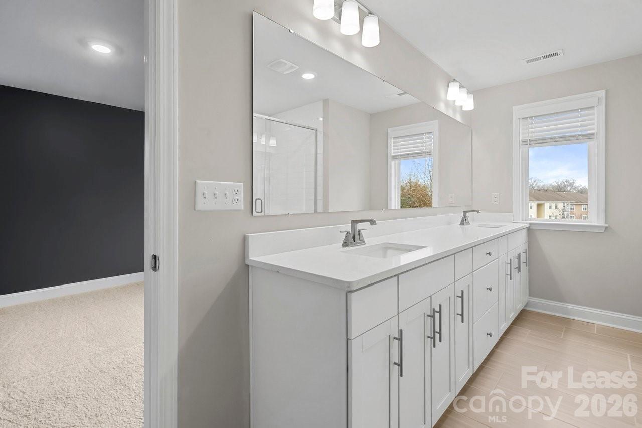 1515 Hidden Falls Road Charlotte, NC 28206 - Photo 22 of 35 a bathroom with 2 sink and a mirror