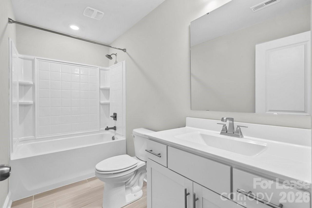 1515 Hidden Falls Road Charlotte, NC 28206 - Photo 27 of 35 a bathroom with a sink toilet and shower