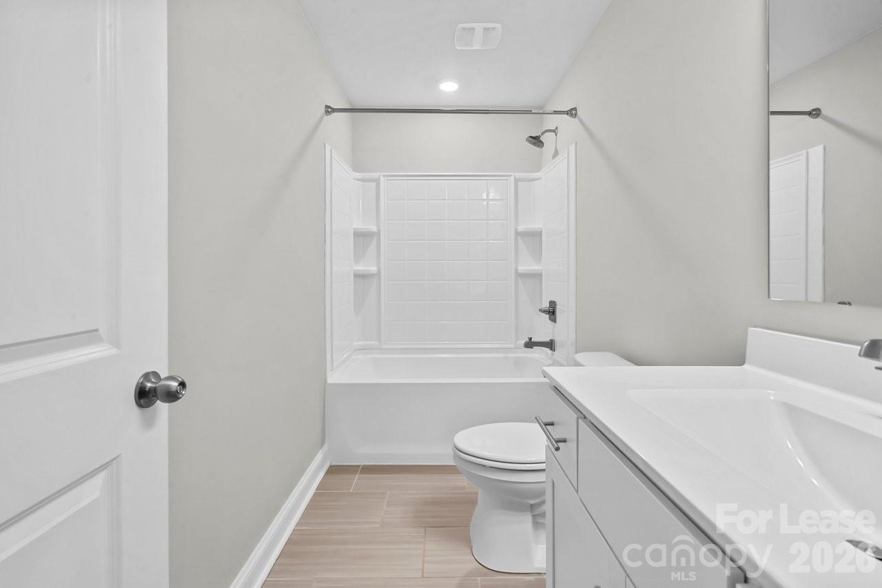 1515 Hidden Falls Road Charlotte, NC 28206 - Photo 28 of 35 a bathroom with a toilet and a shower