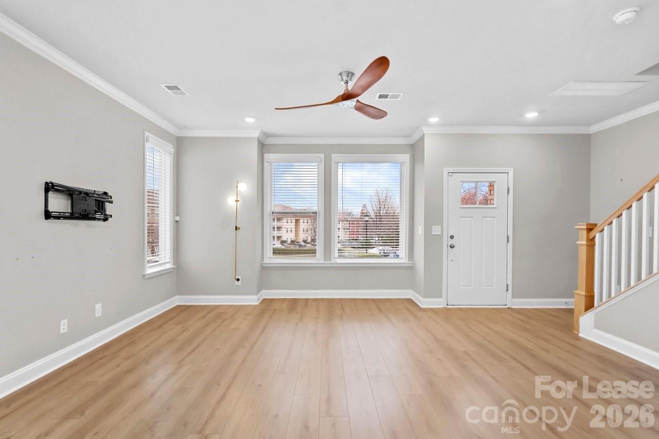 1515 Hidden Falls Road Charlotte, NC 28206 - Photo 5 of 35 a view of an empty room with wooden floor and a window