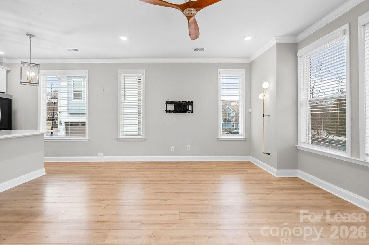1515 Hidden Falls Road Charlotte, NC 28206 - Photo 9 of 35 a view of an empty room with wooden floor and a window