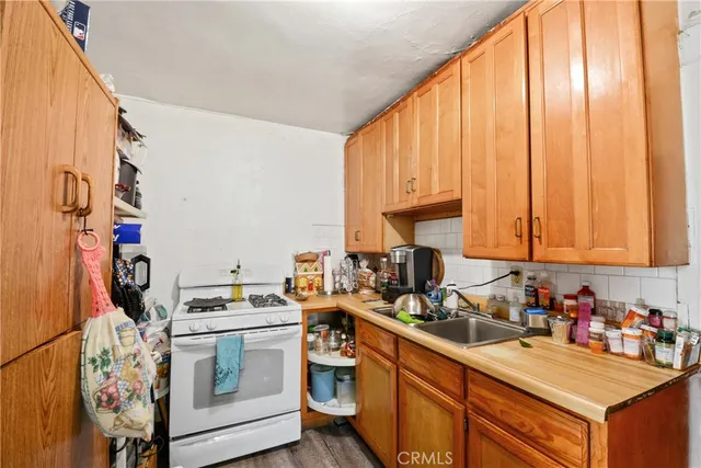 a kitchen with a stove a sink and a microwave
