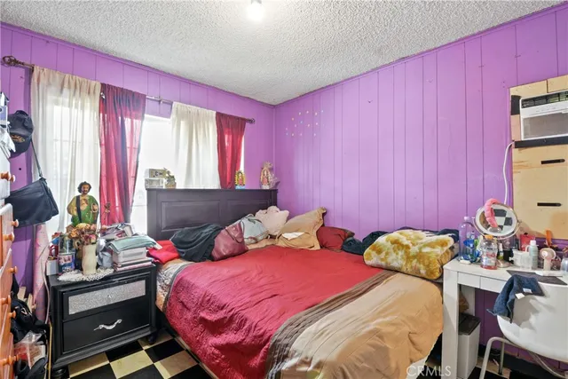 a bedroom with two beds and a chandelier